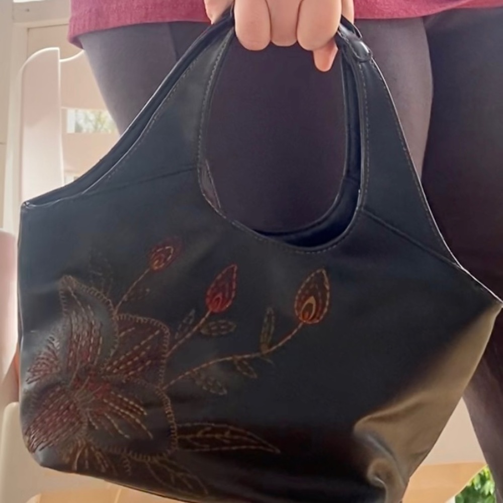 Small handbag with embroidered design.